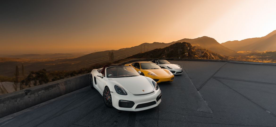 sports cars in a scenic road