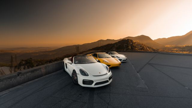 sports cars in a scenic road