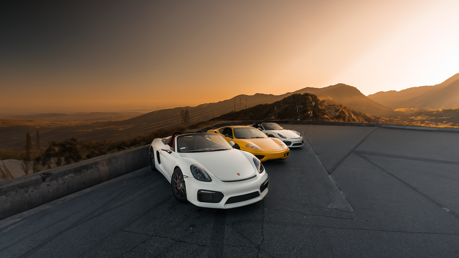 sports cars in a scenic road
